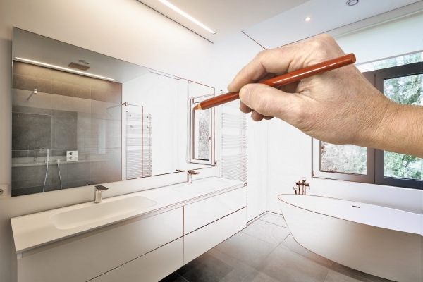 一个人拿着铅笔说明浴室重新设计的概念