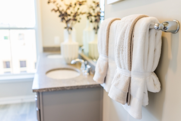 现代浴室，有两个水槽和毛巾挂在毛巾架上。